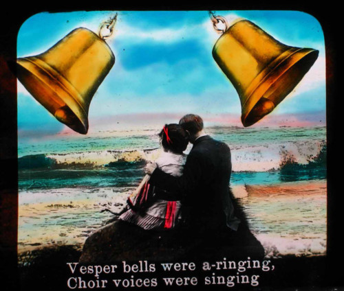 Illustrated song slide of two lovers under wedding bells