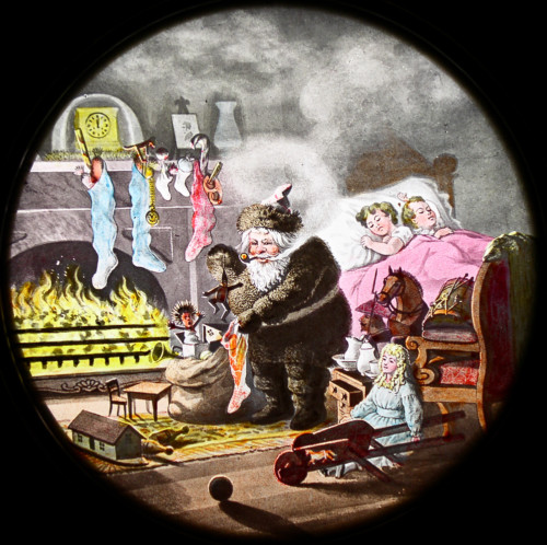 Slide painting of Santa Claus filling stockings while children are sleeping.